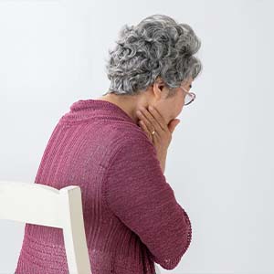 Young Woman Holding the Side of Her Face in Pain