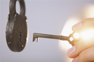 Hand Unlocking Old Fashioned Lock